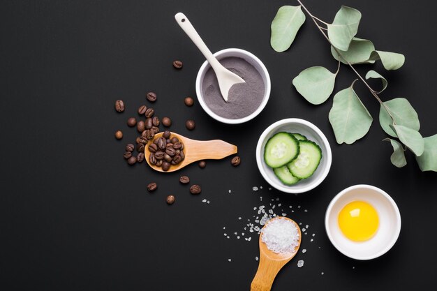 Photo natural ingredients for making diy skin care cosmetic. set of various organic ingredients on black table background.