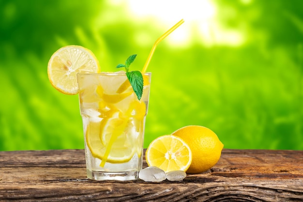 Natural lemonade with mint and fresh fruit on wooden table