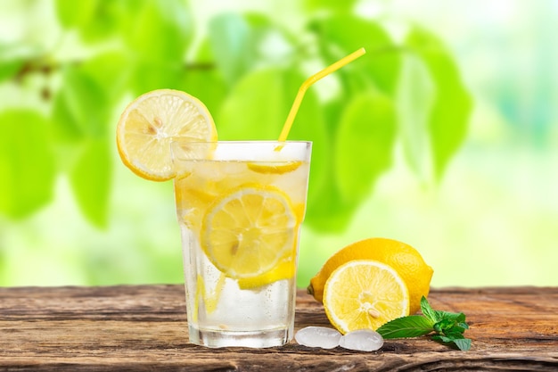 Natural lemonade with mint and fresh fruit on wooden table