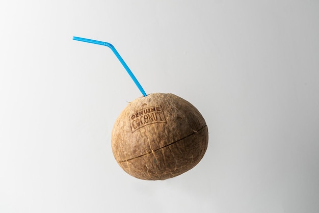 A natural organic coconut with a straw isolated tropical summer fresh