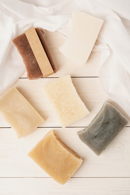 Natural organic cosmetics. Stack of handmade soap on white wooden background, mockup design