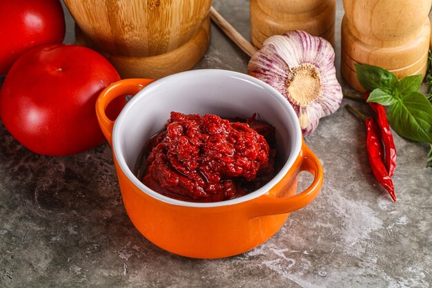 Natural organic red tomato paste in the bowl