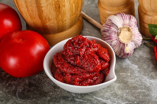 Natural organic red tomato paste in the bowl