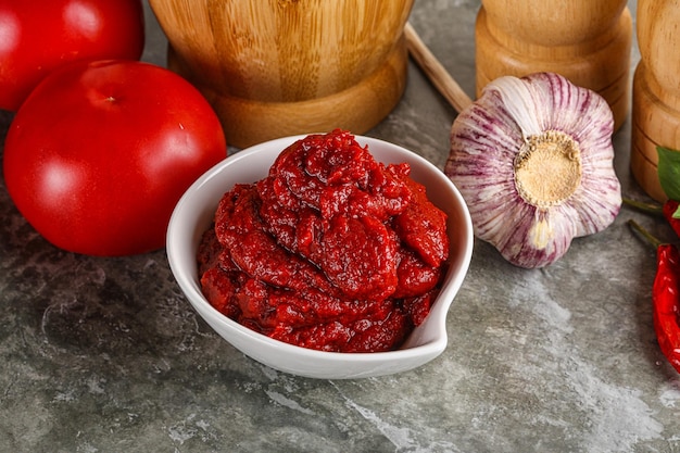 Natural organic red tomato paste in the bowl