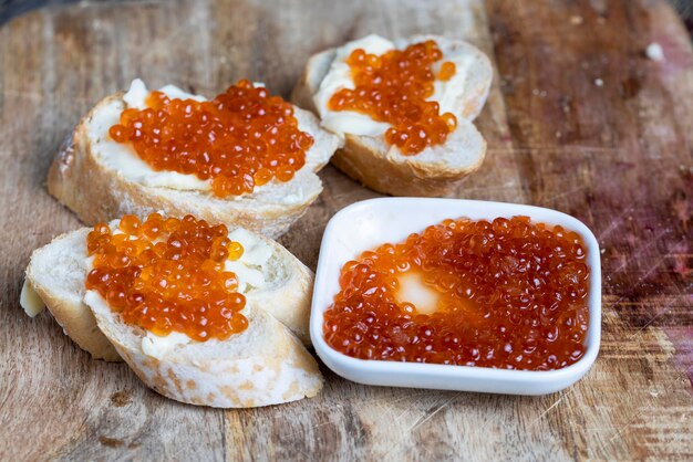 Natural red salmon caviar with baguette and butter