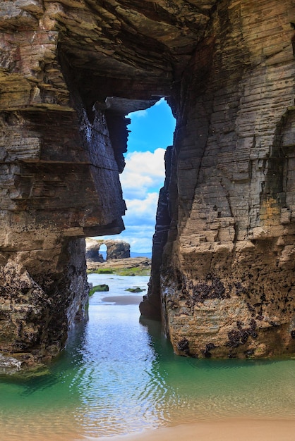 Natural rock arches on Cathedrals beach in low tide (Cantabric coast, Lugo, Galicia, Spain).