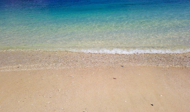 Natural splashing wave sea stone beach on sunny day at Phuket island.