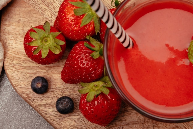 Natural strawberry juice with strawberries and blueberries