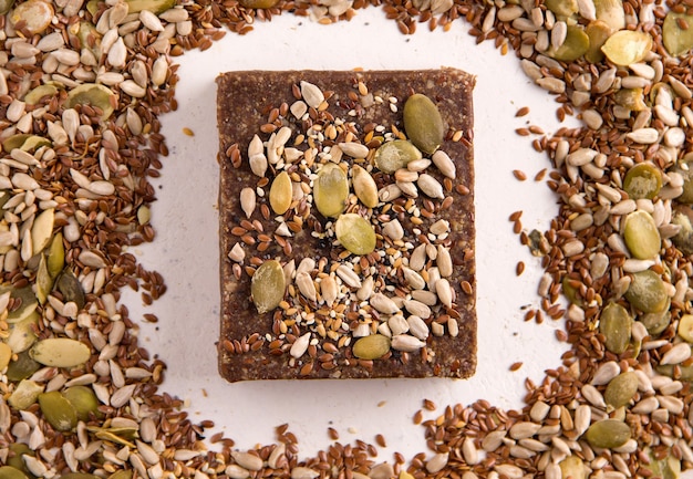 Natural sweets without sugar. Halva on a white background next to the ingredients. View from above