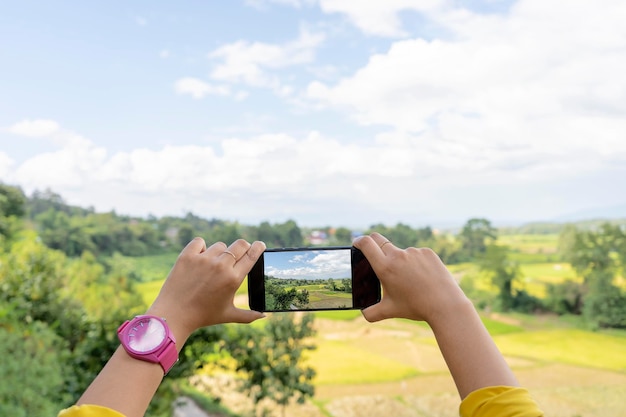 Natural tourism in Thailand in the north A woman who is using a smartphone to take pictures to record the story of her travel