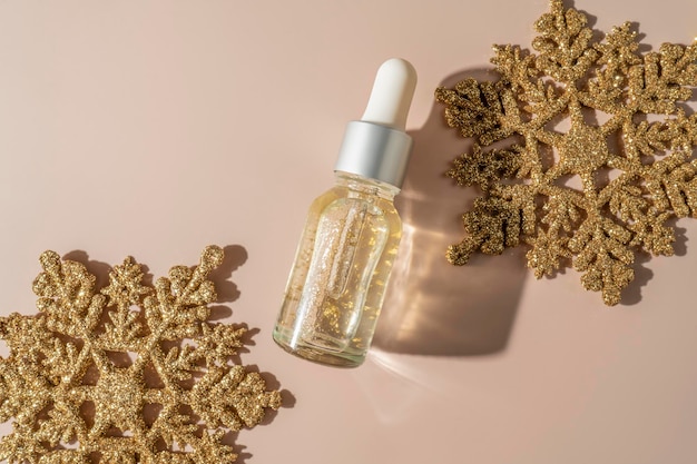 A natural transparent hyaluronic face serum or essential oil lying on a beige background