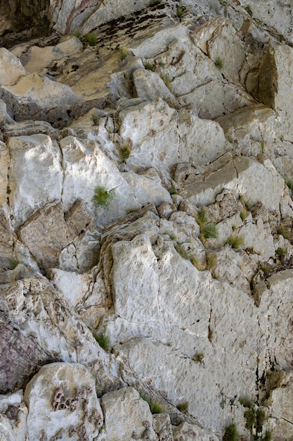 Natural wavy rocky formation along the river. Abstract rough natural background