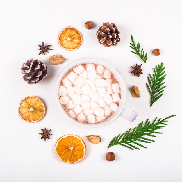 Natural zero waste decoration for christmas laid out in a round frame with a cup of cocoa in the middle.