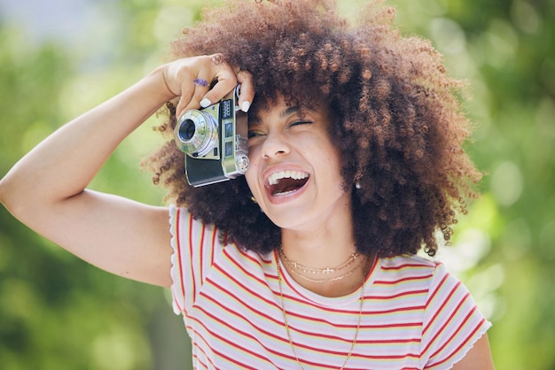 Nature afro and black woman with photography camera taking happy picture memory with retro style African hipster girl with smile in park using vintage photographer equipment to capture moment