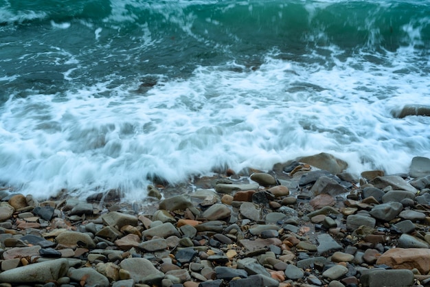 Nature background with sea waves hitting the sea shore Scenic view of sea against cloudy sky