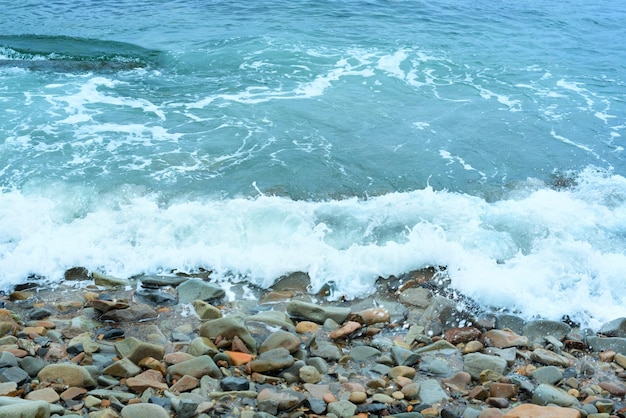 Nature background with sea waves hitting the sea shore Scenic view of sea against cloudy sky