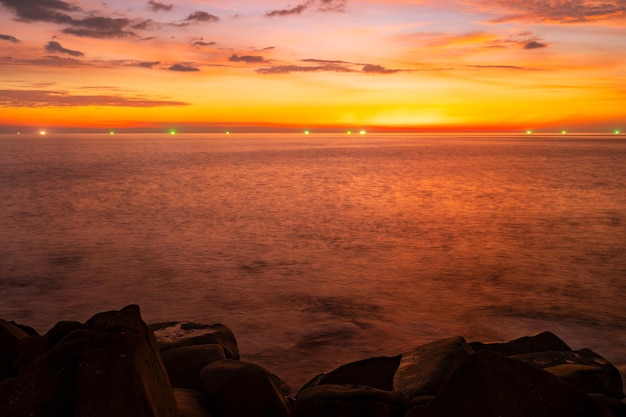 Nature beautiful Light Sunset or sunrise over sea Colorful dramatic majestic scenery Sky with Amazing clouds and waves in sunset sky golden light cloud background