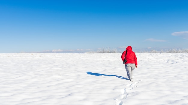 Nature photographer on a snowy field