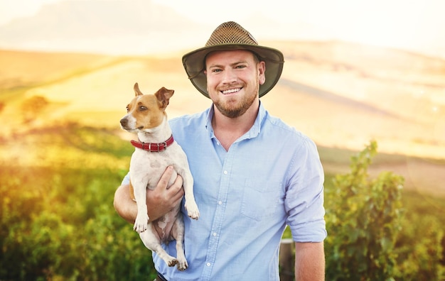 Nature smile and portrait of man with dog in field for bonding training or connection Happy pet and farmer with jack russell puppy in sustainable agriculture or agro environment in countryside