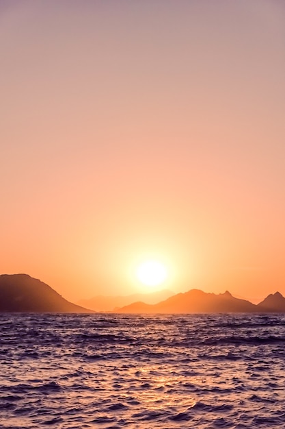 Nature twilight and vintage beach holiday concept  summer sunset at the mediterranean sea coast seascape and mountain view