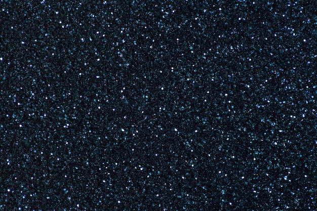 Navy blue sparkling background from small sequins, closeup. Brilliant backdrop.