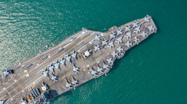 Navy Nuclear Aircraft carrier, Military navy ship carrier full loading fighter jet aircraft, Aerial view.