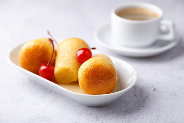 Neapolitan Rum baba with a cocktail cherry Small yeast cakes soaked in rum syrup Italian pastry