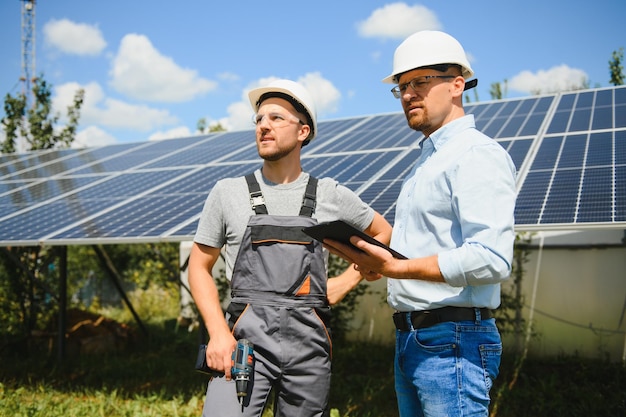 Near the solar panels the employee shows the work plan to the boss