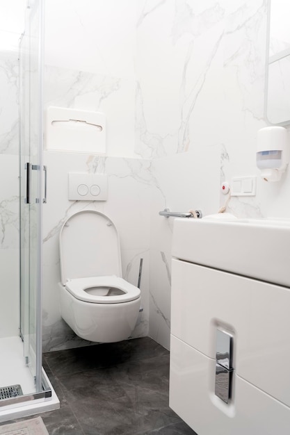 Neat clean bathroom in a hospital with a call button next to the toilet Patient care comfort and convenience