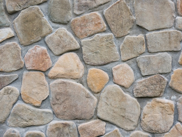 Neatly stacked rough cobblestone wall texture