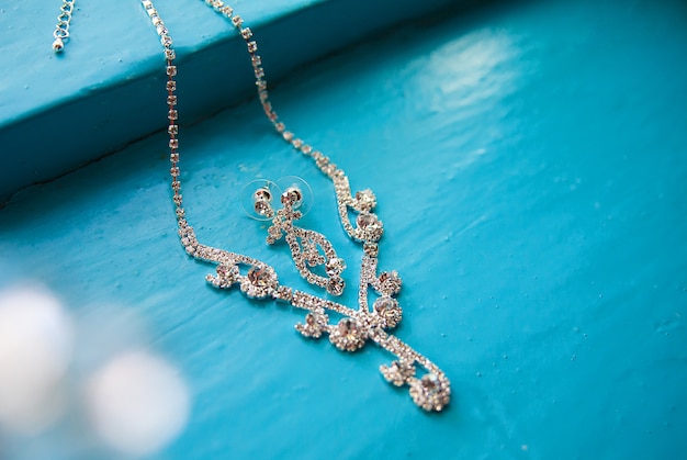 Necklace and earrings on a blue