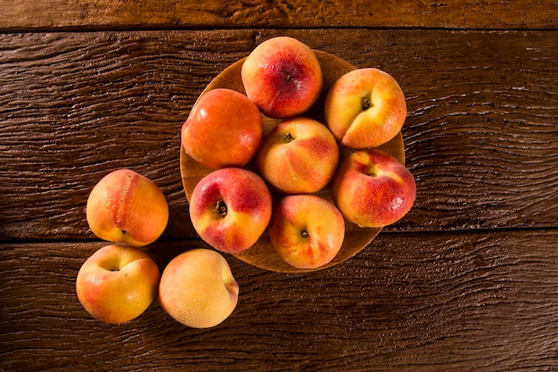 Nectarines on wooden table.