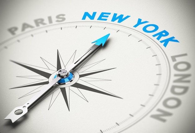 Photo needle of a compass pointing the word new york with blur effect and paper background