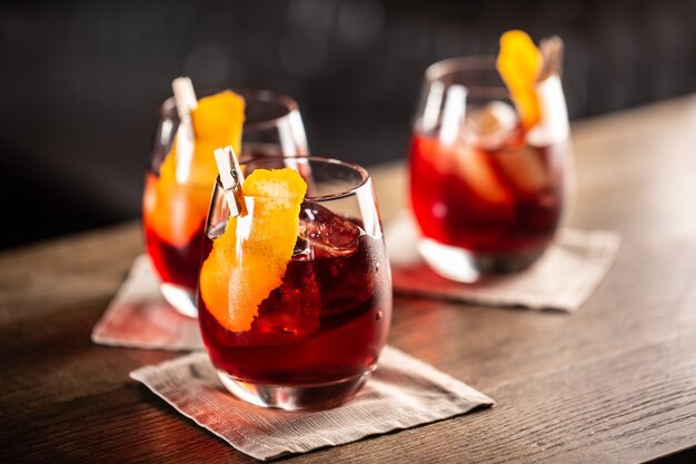 Negroni classic cocktail and gin short drink with sweet vermouth, red bitter liqueur and dried orange garnish.