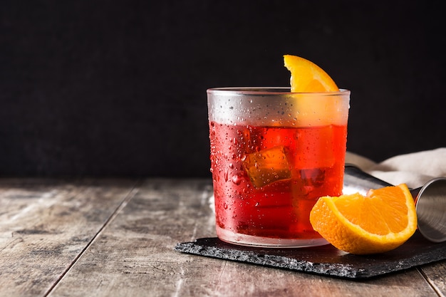 Negroni cocktail in glass on wooden table