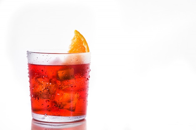 Negroni cocktail with piece of orange in glass isolated on white, copyspace