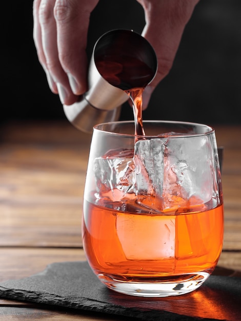 Negroni cocktail on a wooden table. Copy space.