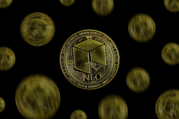 NEO coin and a mans hand on a black background A symbol of technology and a new means of currency settlement