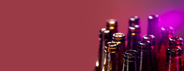 Neon colored beer bottles close up on bright studio background