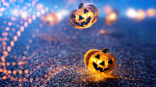 Neon glowing pumpkin head on abstract blurred bokeh background. Festive Halloween background with cobwebs and pumpkin.