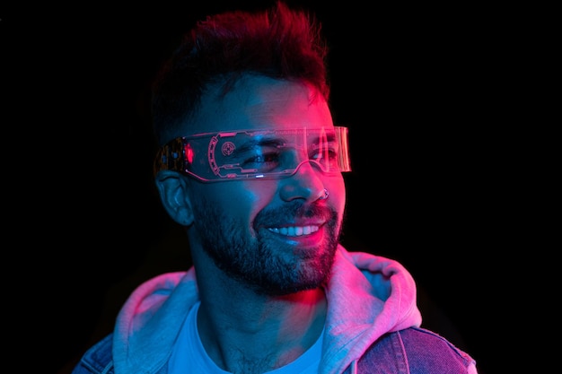 Neon light studio close-up portrait of serious man model with mustaches and beard in sunglasses