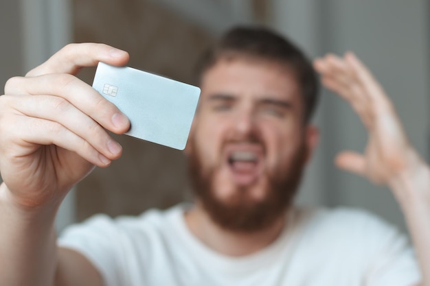 Nervous sad upset confused young man stressed worried guy having problem with paying buying online