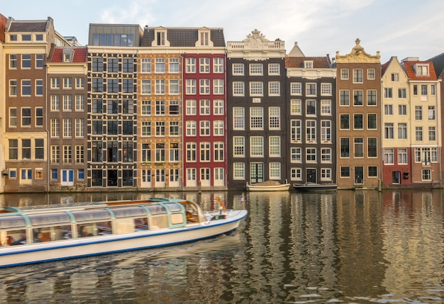 Netherlands. Classic canal houses in Amsterdam. Tourist boat