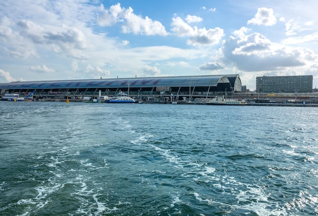 Netherlands. Sunny day in Amsterdam. View from the ferry on the Amstel river to the Central Station