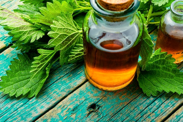 Nettle essence in glass bottle.Healing herbs.Stinging nettles in herbal medicine