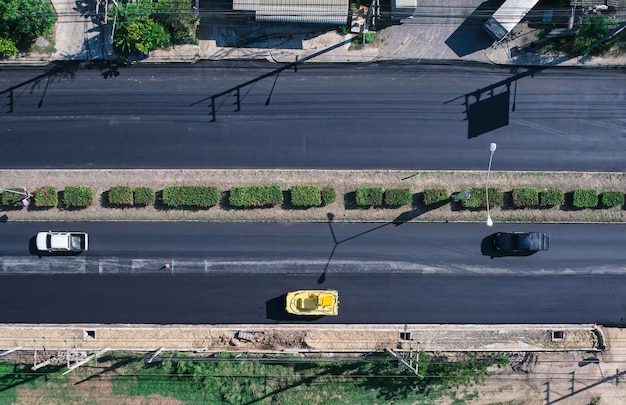 New asphalt road and road roller working in improvement project