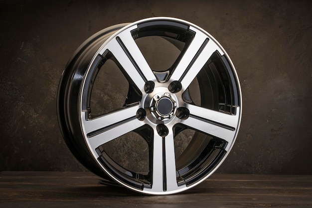 New black alloy wheels on a dark textured black background wheel for car spare parts auto repair tire shop