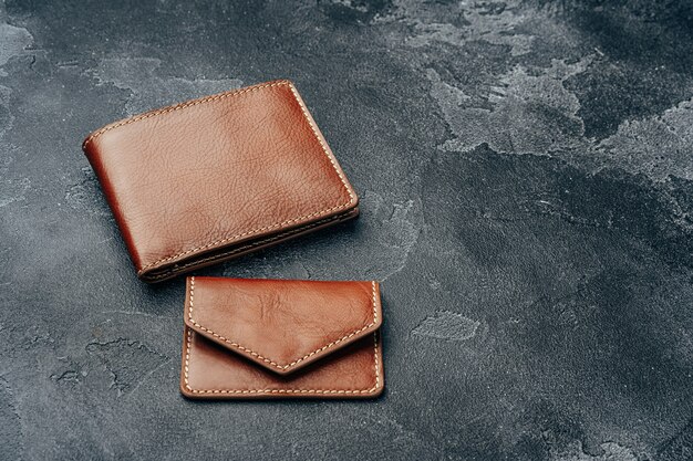 New brown leather wallet on dark concrete