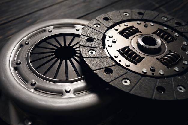 New car clutch kit on a dark wooden background. Close up