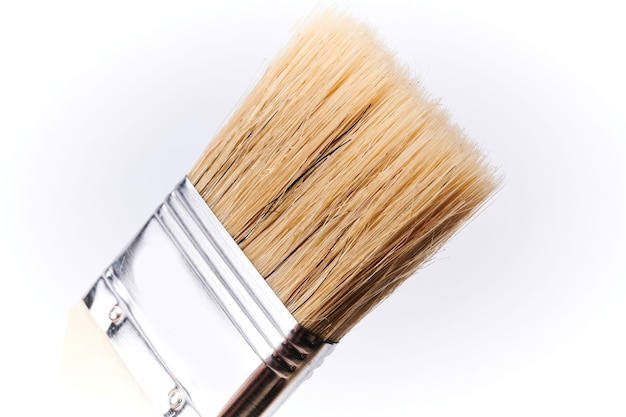 New clean wooden paint brush isolated on white background closeup